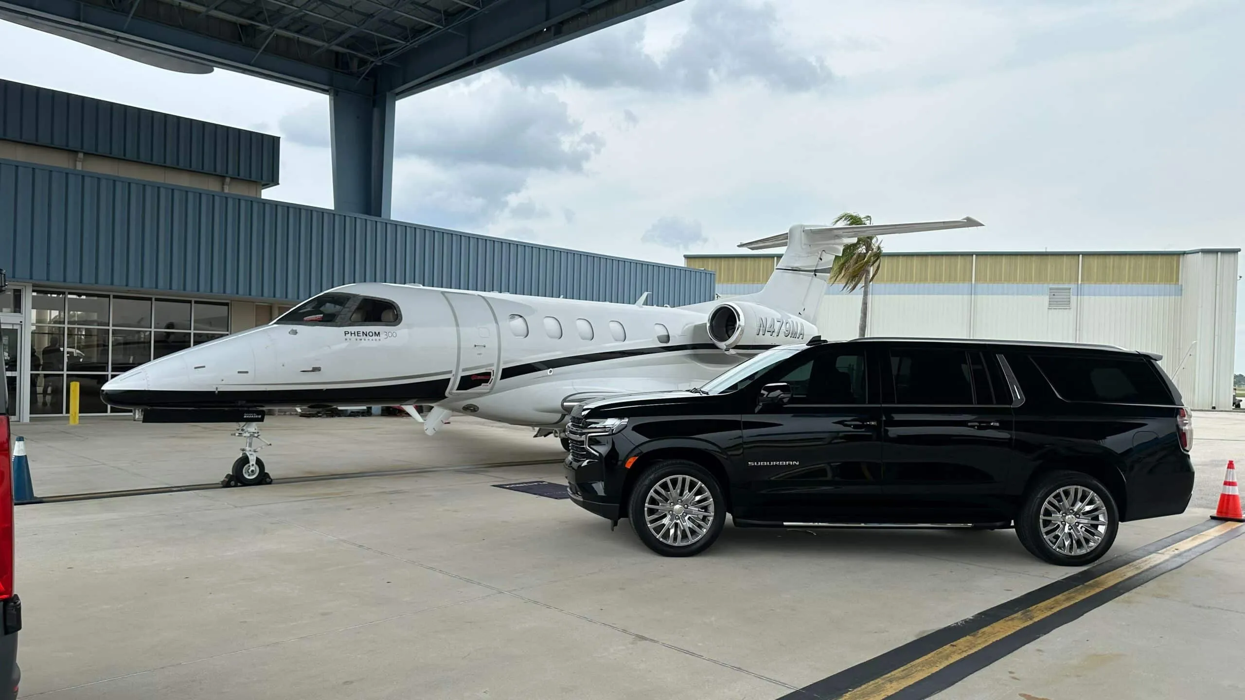 Luxury chauffeur loading luggage for LAX airport transfer