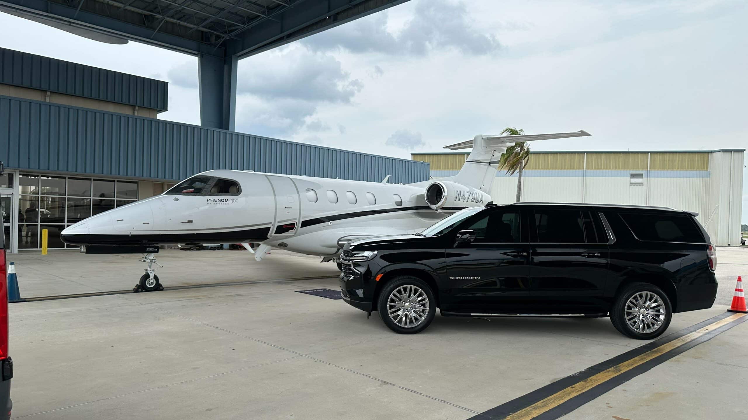 Luxury chauffeur loading luggage for LAX airport transfer