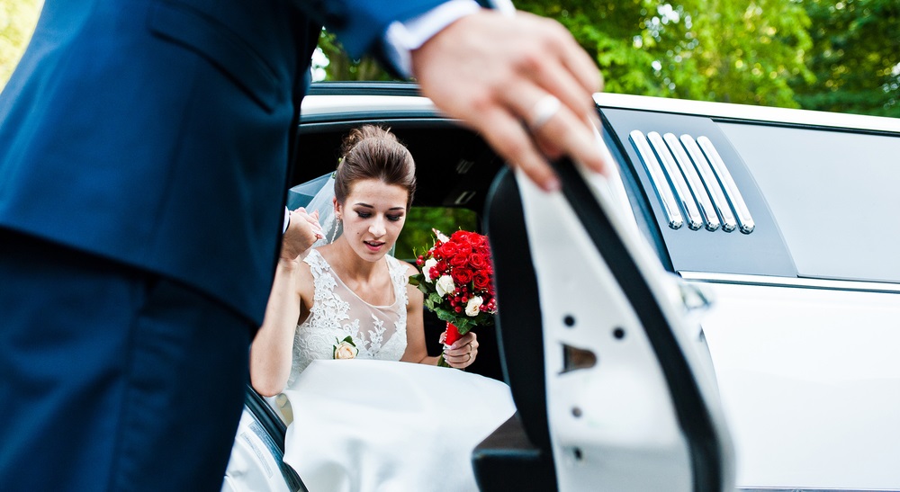  bride getting out of los angeles limousine on wedding day